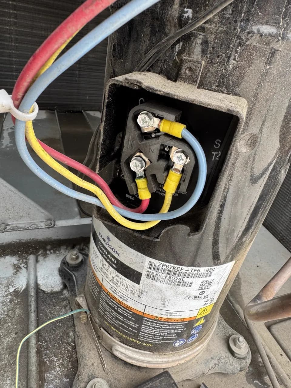 Compressor terminal wiring on an outdoor AC unit during a repair