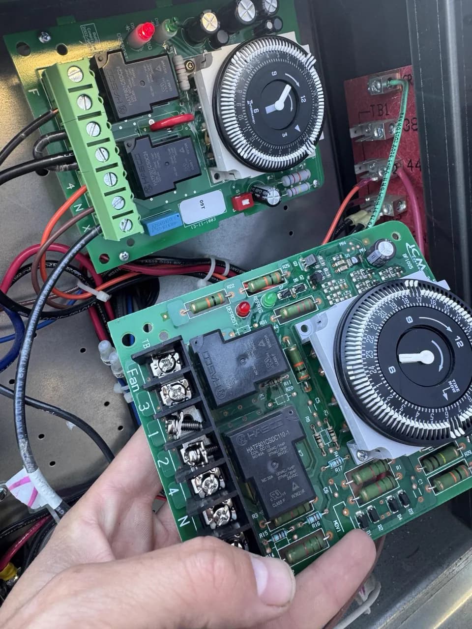 Two control boards with timers held during an equipment repair