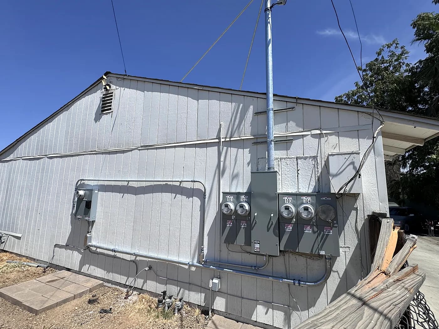 The side of a multi-unit building with a new five-meter main panel