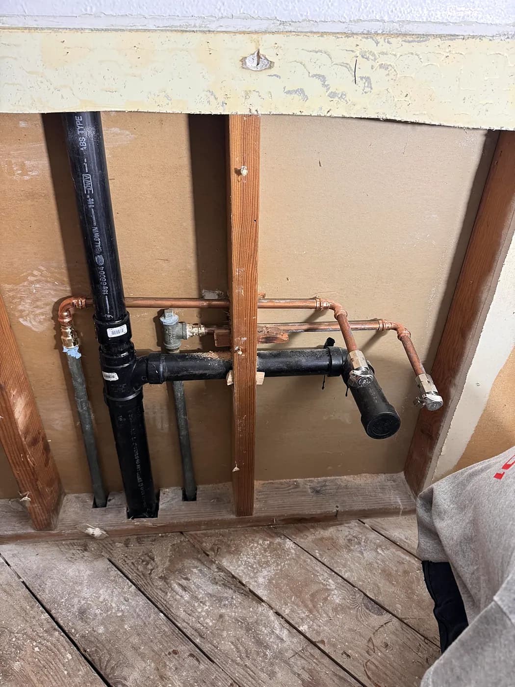 New drain and supply lines inside an opened wall