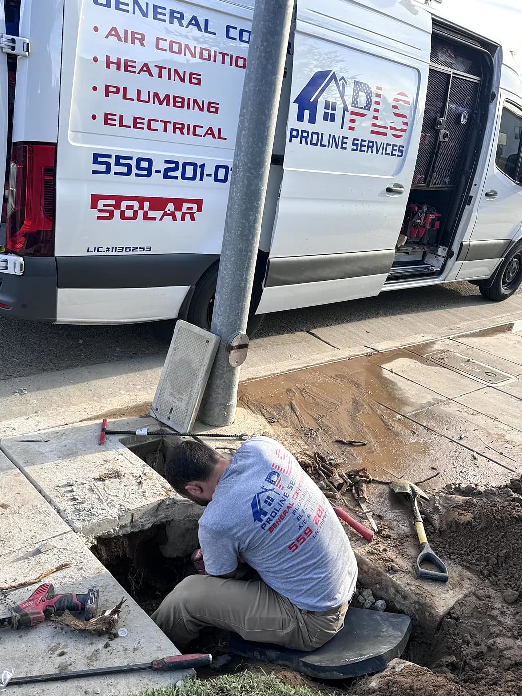 A ProLine plumber working in an excavation on a buried line