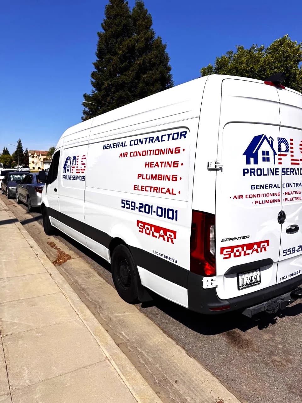 Side of the ProLine Services van listing general contractor, air conditioning, heating, plumbing and electrical
